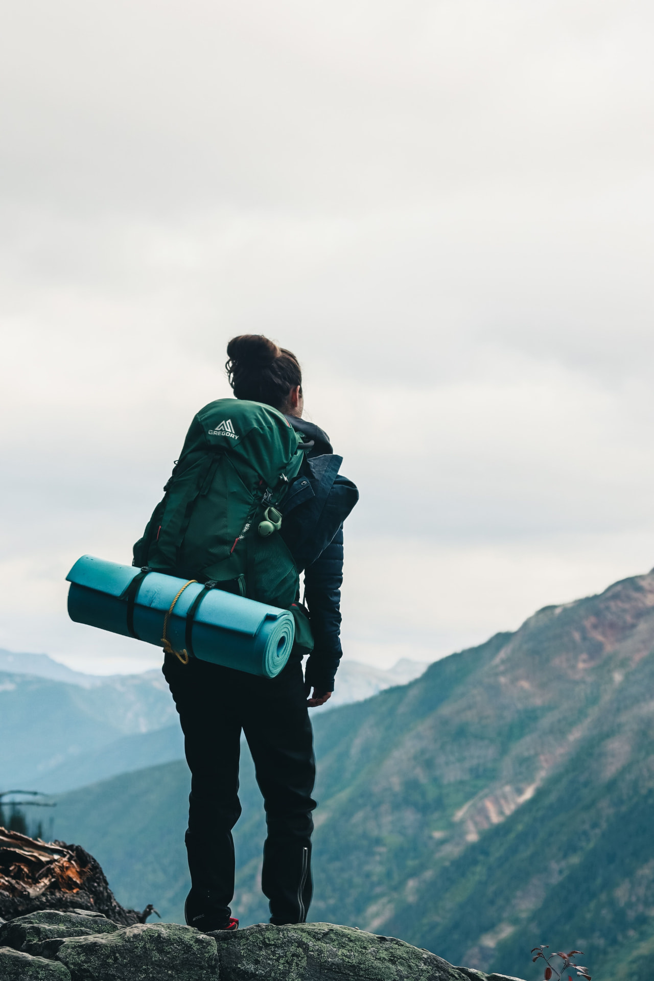 A female traveller with a backpack in the mountains